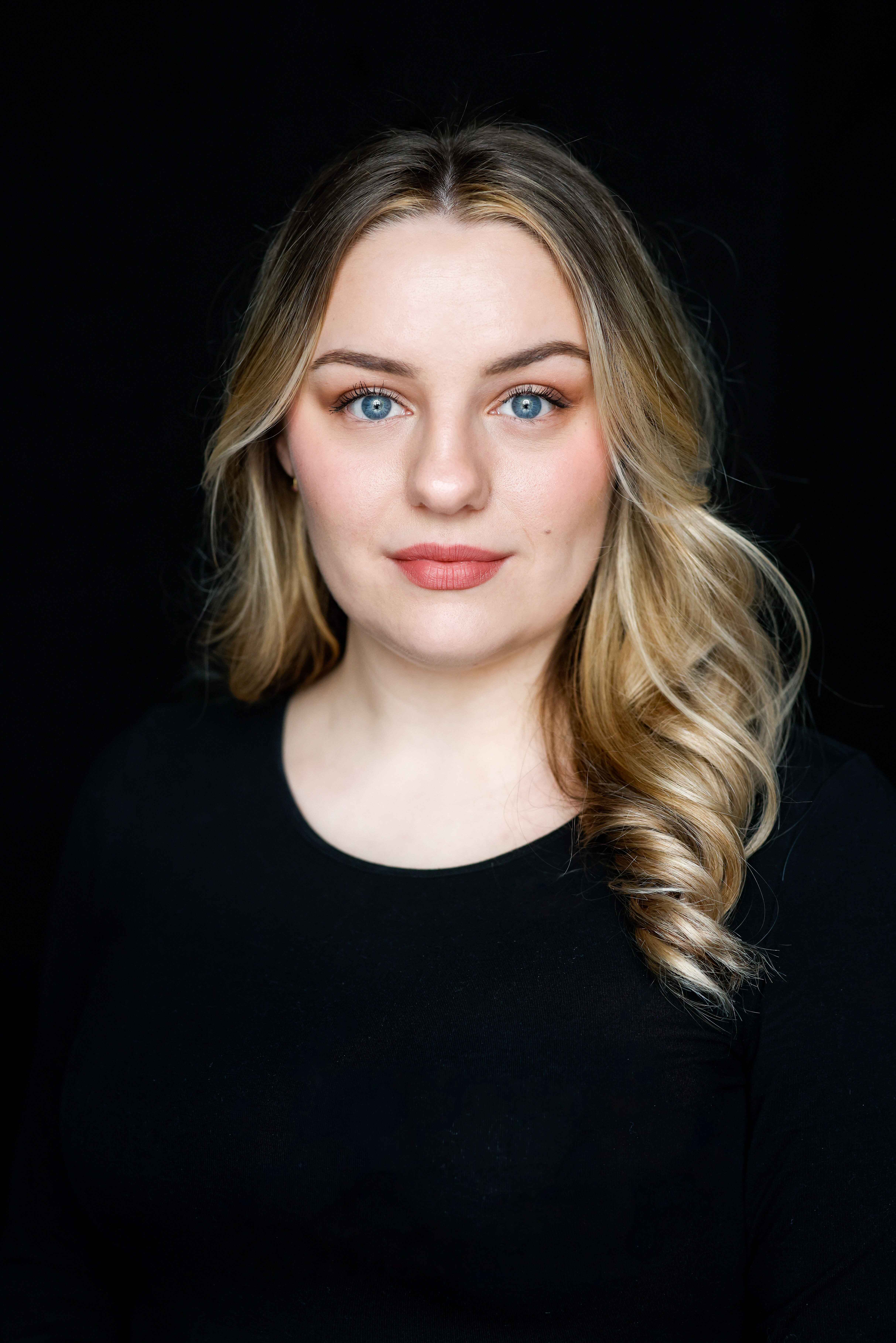 Alina Adams in front of a black background