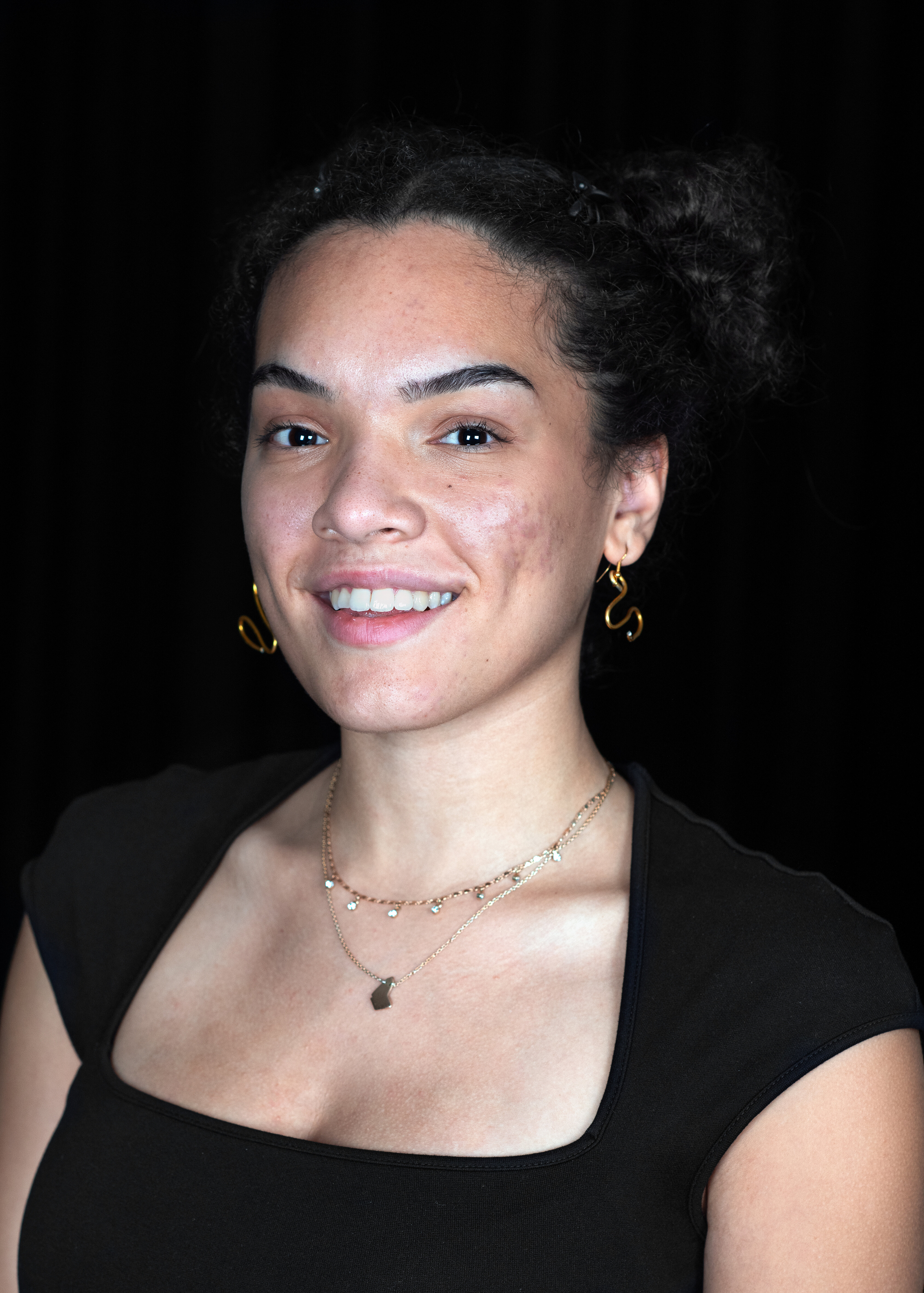 Isabella Kanini Fischer in front of a black background